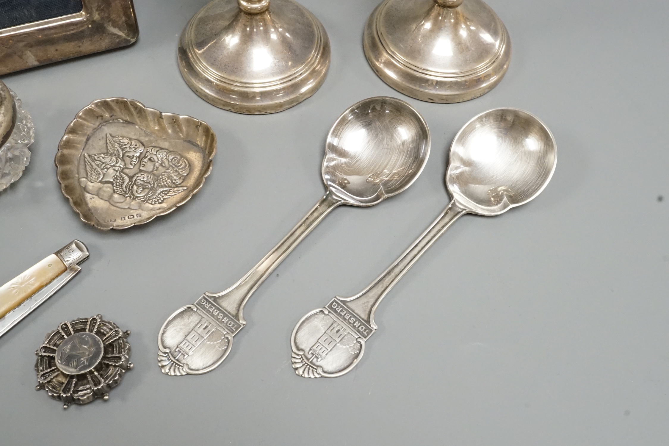 Sundry silver and white metal including a pair of modern candlesticks and a similar photograph frame.